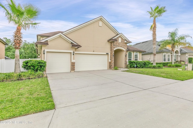 200 Ellsworth Cir, Saint Johns, FL 32259 - traditional home with stone siding, an attached garage, stucco siding, and driveway