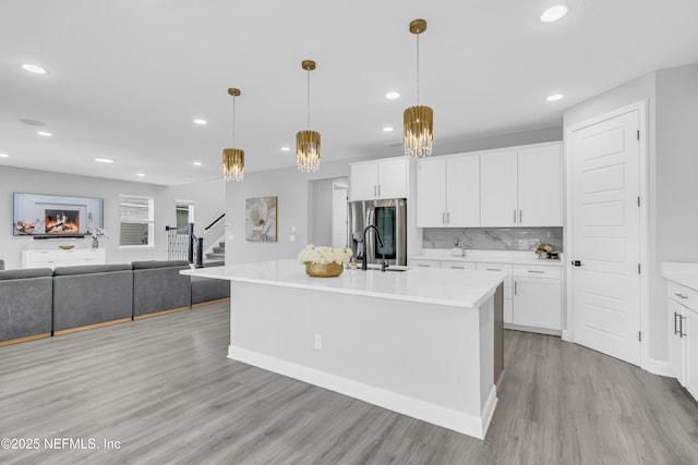 194 Napo Way, Saint Johns, FL 32259 - kitchen with stainless steel fridge, light wood-type flooring, light countertops, recessed lighting, and white cabinetry