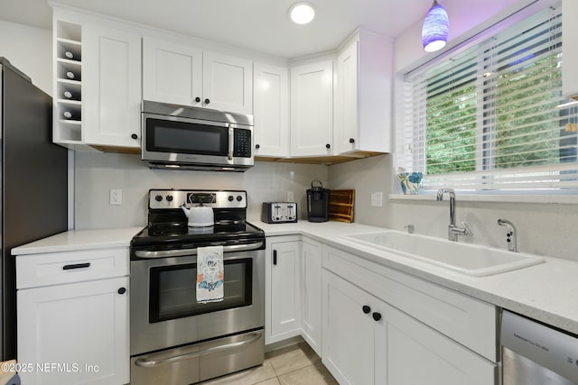 2734 Colonies Dr, Jacksonville Beach, FL 32250 - kitchen with appliances with stainless steel finishes, a sink, white cabinets, and light countertops