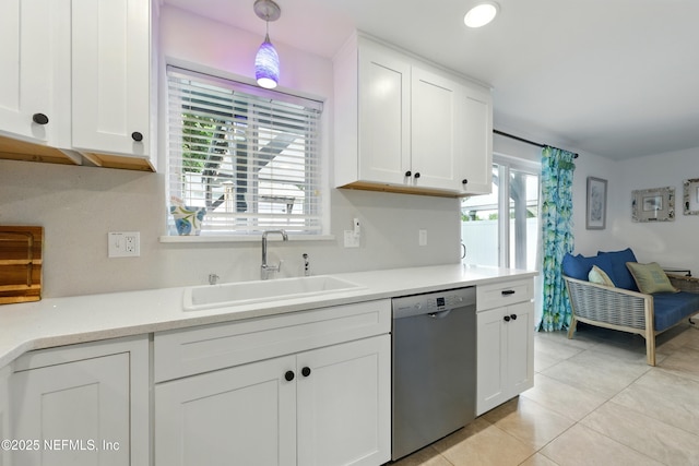 2734 Colonies Dr, Jacksonville Beach, FL 32250 - kitchen featuring stainless steel dishwasher, a sink, light tile patterned flooring, and white cabinets