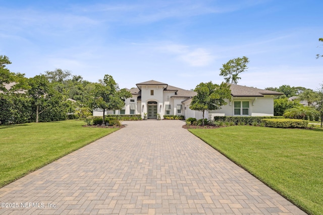 1332 N Loop Pkwy, Saint Augustine, FL 32095 - view of front of house with decorative driveway, stucco siding, and a front lawn
