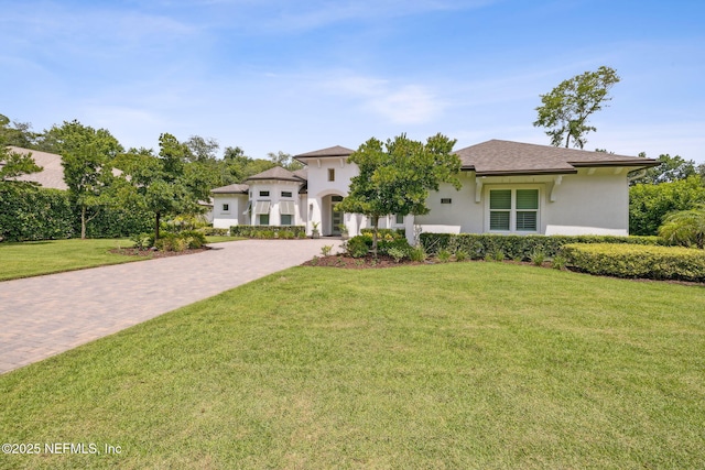 1332 N Loop Pkwy, Saint Augustine, FL 32095 - view of front facade featuring stucco siding, decorative driveway, and a front lawn