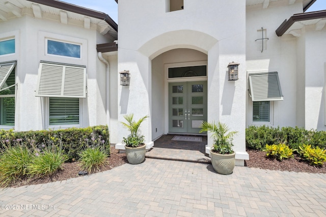 1332 N Loop Pkwy, Saint Augustine, FL 32095 - view of exterior entry featuring stucco siding and french doors