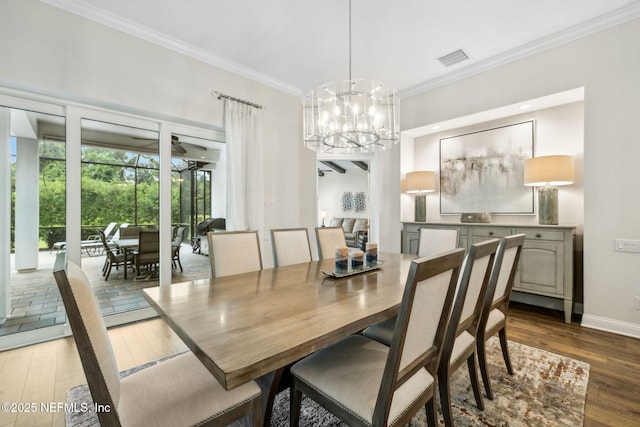 1332 N Loop Pkwy, Saint Augustine, FL 32095 - dining area featuring crown molding, wood finished floors, and a chandelier