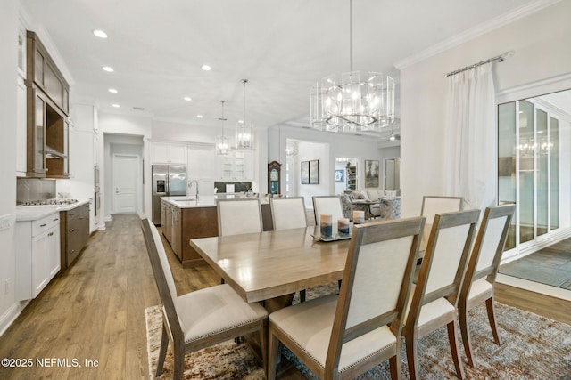 1332 N Loop Pkwy, Saint Augustine, FL 32095 - dining room with a chandelier, light wood-style flooring, recessed lighting, and ornamental molding