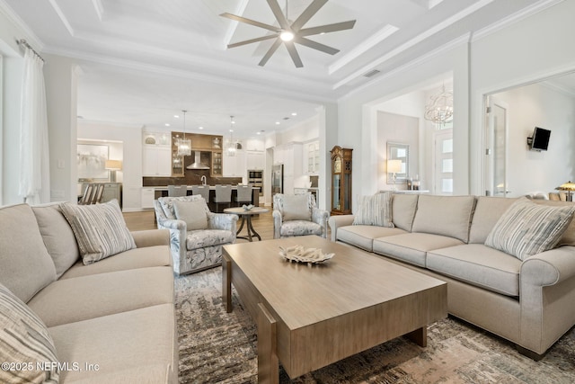 1332 N Loop Pkwy, Saint Augustine, FL 32095 - living room with crown molding, a ceiling fan, a chandelier, recessed lighting, and light wood-style floors