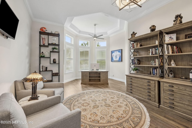 1332 N Loop Pkwy, Saint Augustine, FL 32095 - living area featuring wood finished floors, a tray ceiling, a ceiling fan, and crown molding