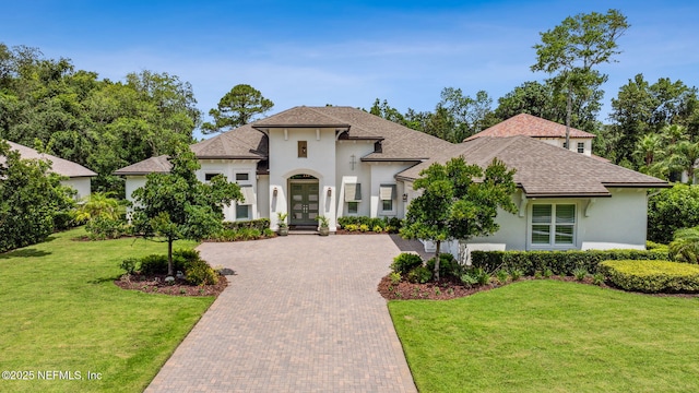 1332 N Loop Pkwy, Saint Augustine, FL 32095 - french provincial home with stucco siding, french doors, decorative driveway, and a front yard