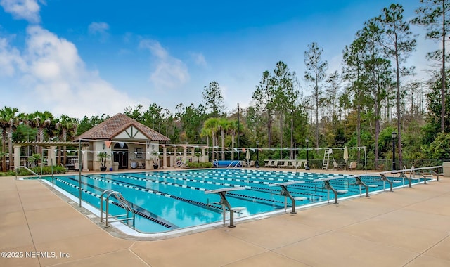 1332 N Loop Pkwy, Saint Augustine, FL 32095 - community pool with a patio and view of scattered trees