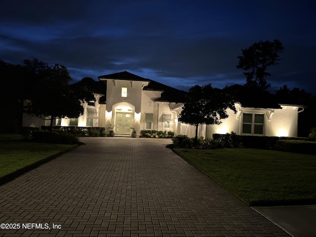 1332 N Loop Pkwy, Saint Augustine, FL 32095 - mediterranean / spanish home featuring curved driveway, stucco siding, and a lawn