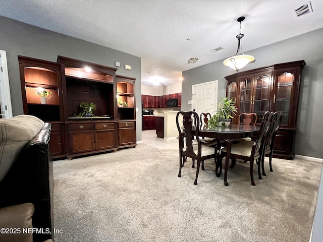 3610 Kirkpatrick Cir Unit 8, Jacksonville, FL 32210 - dining area with light carpet and a textured ceiling