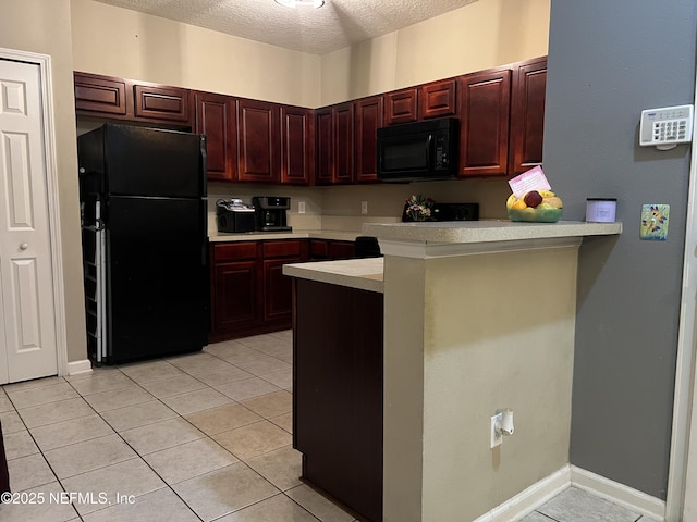 3610 Kirkpatrick Cir Unit 8, Jacksonville, FL 32210 - kitchen with black appliances, light countertops, a textured ceiling, a peninsula, and light tile patterned floors