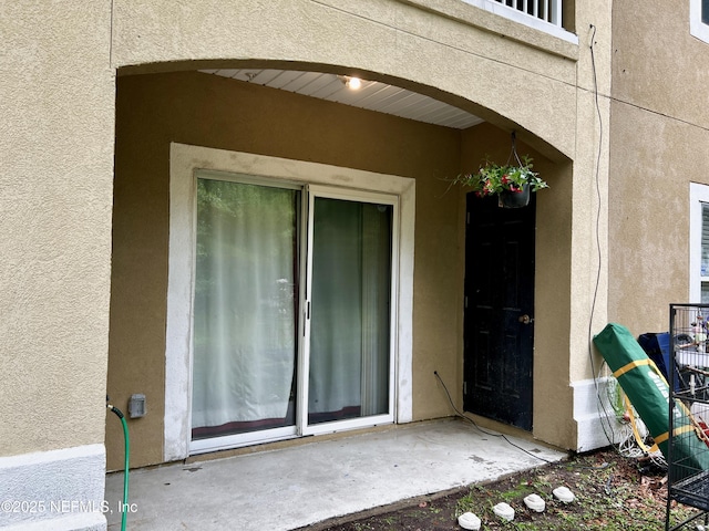3610 Kirkpatrick Cir Unit 8, Jacksonville, FL 32210 - property entrance with stucco siding and a patio