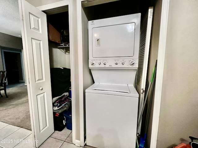 3610 Kirkpatrick Cir Unit 8, Jacksonville, FL 32210 - laundry room featuring estacked washer and dryer and light tile patterned floors