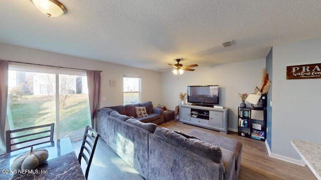1318 Lake Shore Blvd, Jacksonville, FL 32205 - living area with ceiling fan, a textured ceiling, wood finished floors, and baseboards