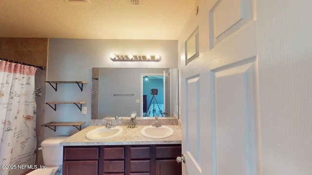 1318 Lake Shore Blvd, Jacksonville, FL 32205 - bathroom with double vanity, toilet, a textured ceiling, and a shower with curtain
