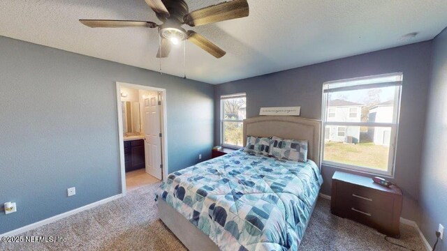 1318 Lake Shore Blvd, Jacksonville, FL 32205 - carpeted bedroom featuring a textured ceiling, baseboards, connected bathroom, and ceiling fan