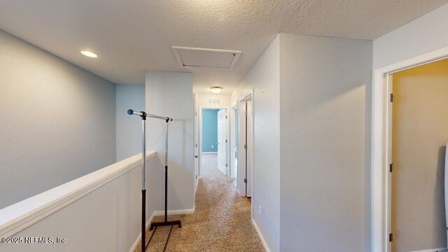 1318 Lake Shore Blvd, Jacksonville, FL 32205 - hall featuring carpet floors, a textured ceiling, baseboards, and attic access