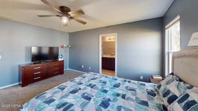 1318 Lake Shore Blvd, Jacksonville, FL 32205 - carpeted bedroom with baseboards, connected bathroom, and a ceiling fan