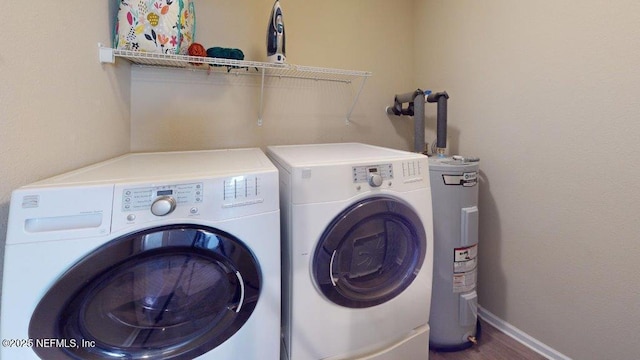 1318 Lake Shore Blvd, Jacksonville, FL 32205 - washroom with washer and clothes dryer, water heater, baseboards, and wood finished floors
