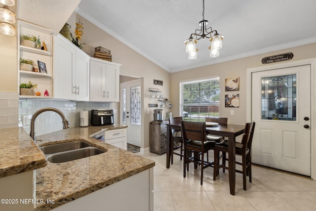 11087 Danzig Way, Jacksonville, FL 32257 - kitchen with open shelves, a sink, lofted ceiling, a chandelier, and white cabinets