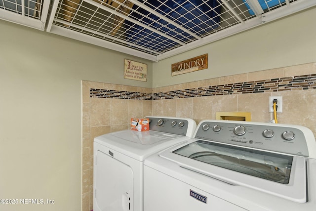 11087 Danzig Way, Jacksonville, FL 32257 - laundry room featuring separate washer and dryer and tile walls