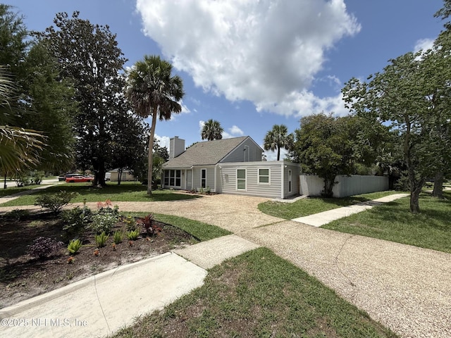 2406 Oakview Dr, Jacksonville, FL 32246 - view of front of home with driveway, a chimney, and a front lawn