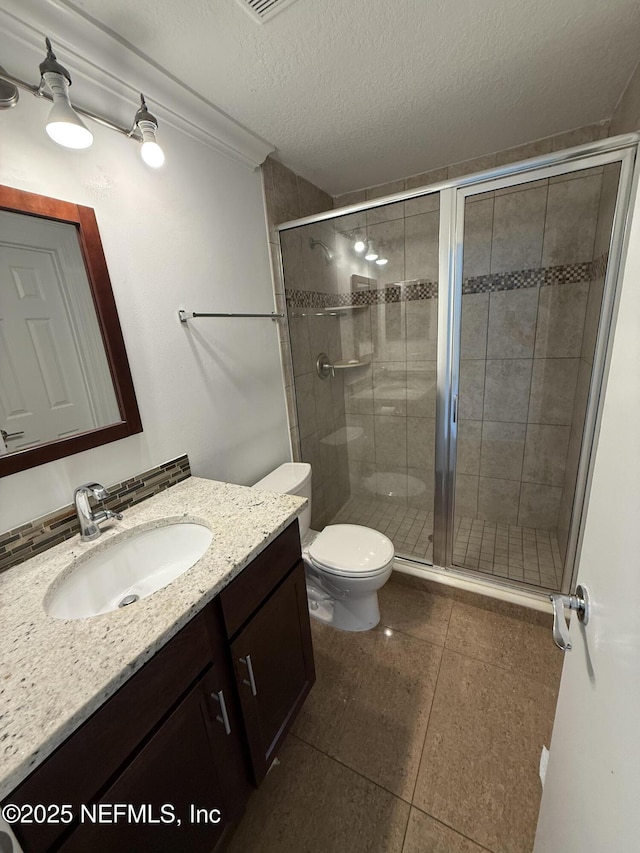 2406 Oakview Dr, Jacksonville, FL 32246 - full bath with vanity, toilet, a stall shower, tile patterned floors, and a textured ceiling