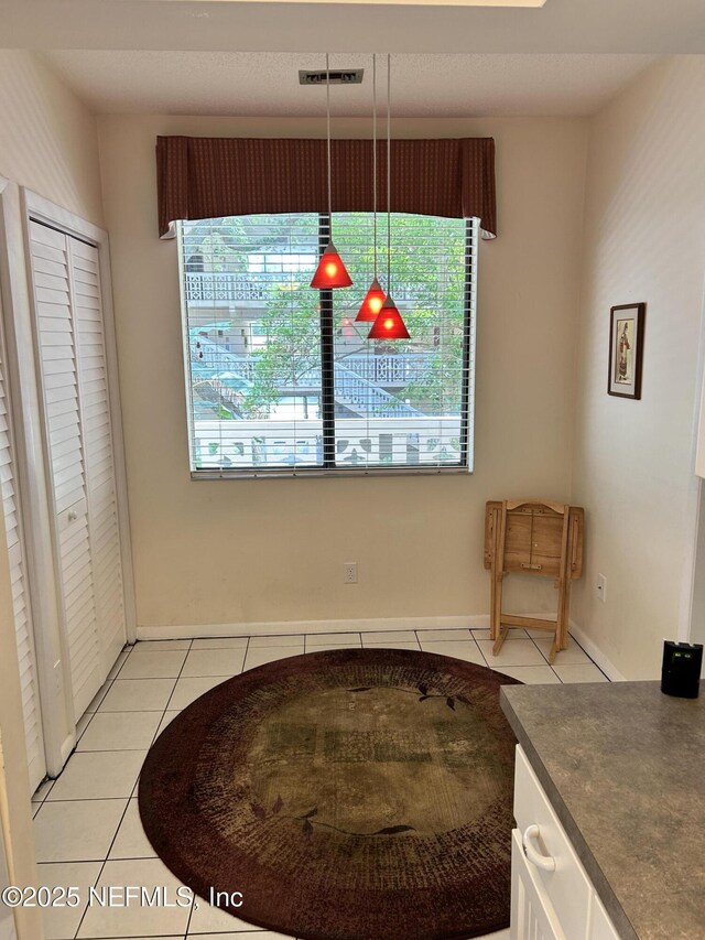 1830 Sevilla Blvd Unit 207, Atlantic Beach, FL 32233 - unfurnished dining area with light tile patterned floors and baseboards