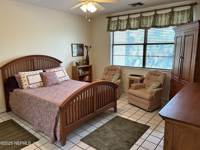 1830 Sevilla Blvd Unit 207, Atlantic Beach, FL 32233 - bedroom featuring light tile patterned floors, a ceiling fan, and a textured ceiling