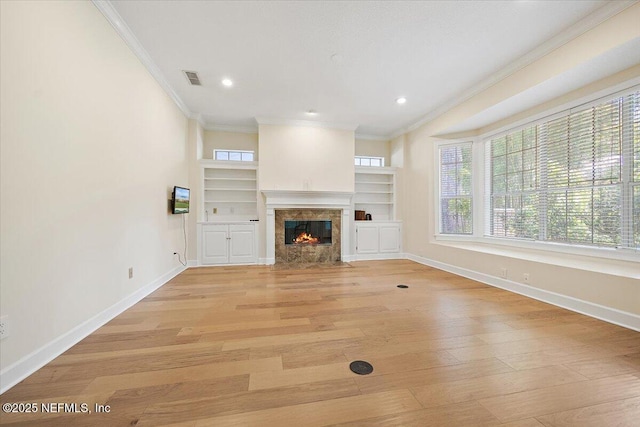 2227 Barefoot Trce, Atlantic Beach, FL 32233 - unfurnished living room with ornamental molding, a high end fireplace, light wood-style flooring, recessed lighting, and built in shelves