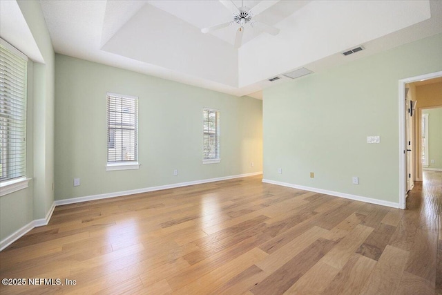 2227 Barefoot Trce, Atlantic Beach, FL 32233 - spare room with light wood-type flooring, a ceiling fan, and a raised ceiling