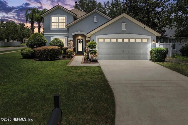 800 Marjories Way, Saint Augustine, FL 32092 - traditional-style home with stucco siding, concrete driveway, a garage, and a front yard