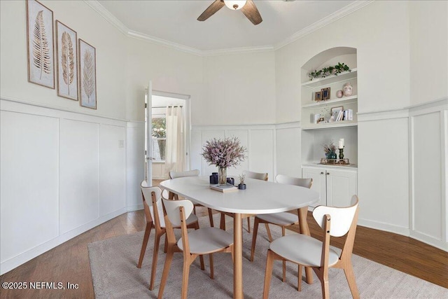 800 Marjories Way, Saint Augustine, FL 32092 - dining area featuring a decorative wall, wood finished floors, built in shelves, ornamental molding, and a ceiling fan