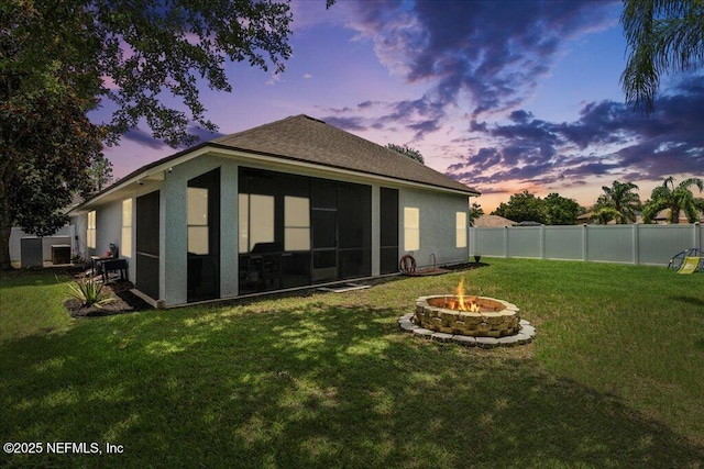 800 Marjories Way, Saint Augustine, FL 32092 - back of property featuring a fire pit, a fenced backyard, stucco siding, and a sunroom