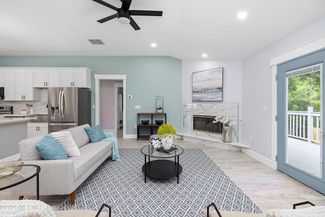 3064 Hickory Glen Dr, Jacksonville, FL 32065 - living room with a ceiling fan, light wood-style flooring, recessed lighting, a fireplace, and baseboards