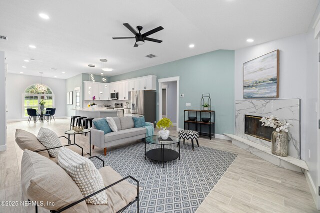 3064 Hickory Glen Dr, Jacksonville, FL 32065 - living room with ceiling fan, recessed lighting, baseboards, a high end fireplace, and light wood finished floors