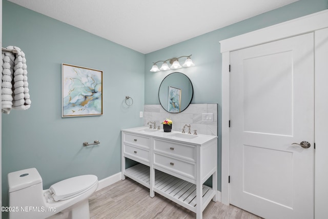 3064 Hickory Glen Dr, Jacksonville, FL 32065 - bathroom featuring toilet, double vanity, wood finished floors, and baseboards