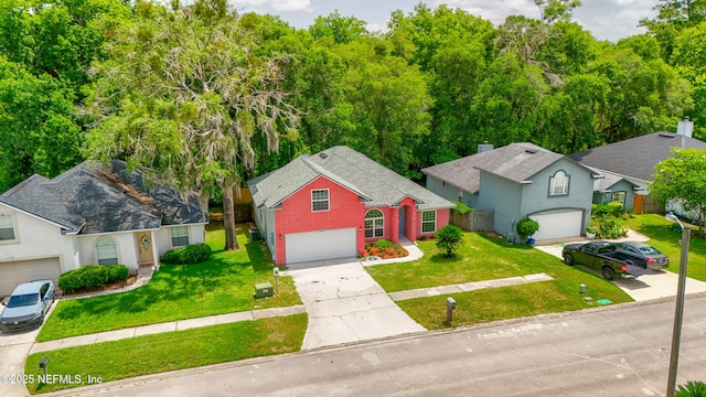 3064 Hickory Glen Dr, Jacksonville, FL 32065 - view of front of property featuring concrete driveway, an attached garage, a front yard, and brick siding