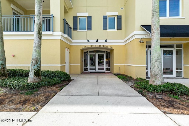 525 3rd St S Unit 513, Jacksonville Beach, FL 32250 - doorway to property with french doors and stucco siding