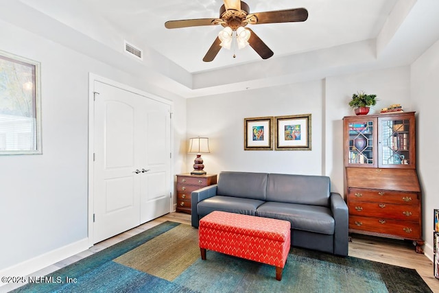 525 3rd St S Unit 513, Jacksonville Beach, FL 32250 - living room with wood finished floors, ceiling fan, and a tray ceiling