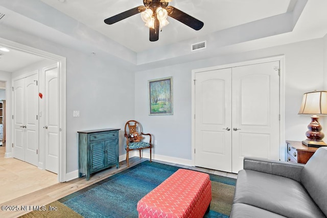 525 3rd St S Unit 513, Jacksonville Beach, FL 32250 - living room with ceiling fan, wood finished floors, and a tray ceiling