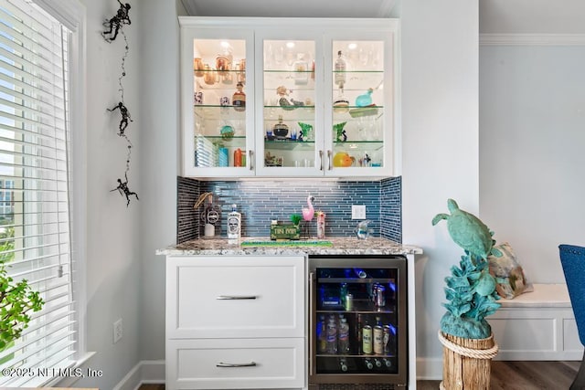 525 3rd St S Unit 513, Jacksonville Beach, FL 32250 - indoor wet bar featuring beverage cooler, tasteful backsplash, crown molding, and wood finished floors