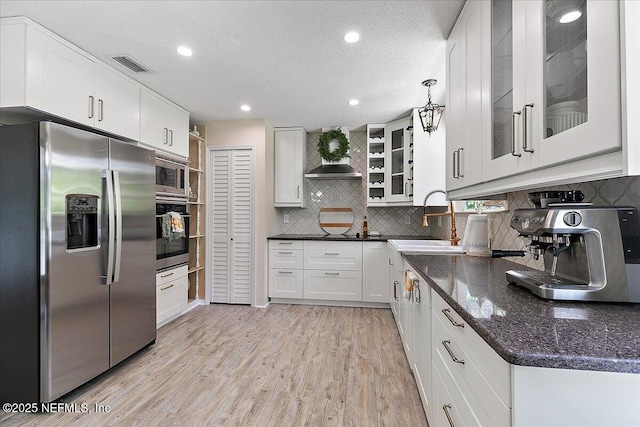 5265 State Rd 13 N, Saint Augustine, FL 32092 - kitchen with stainless steel appliances, open shelves, wall chimney exhaust hood, decorative backsplash, and recessed lighting