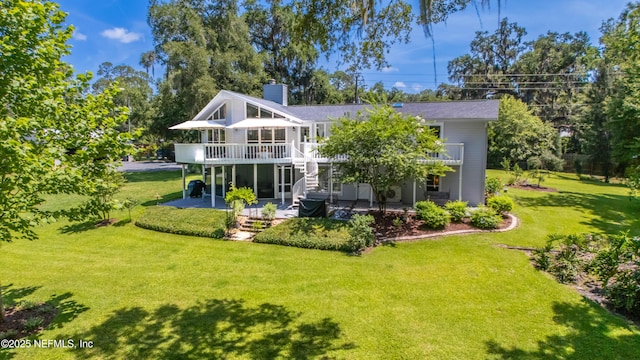 5265 State Rd 13 N, Saint Augustine, FL 32092 - back of property featuring a patio, a chimney, a lawn, and a deck