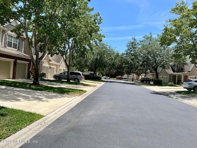 11110 Castlemain Cir S, Jacksonville, FL 32256 - view of asphalt road with curbs and a residential view