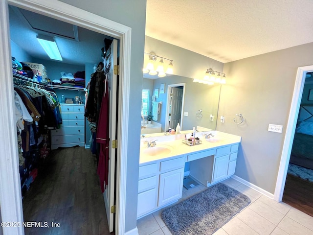 11110 Castlemain Cir S, Jacksonville, FL 32256 - full bath with double vanity, a textured ceiling, a spacious closet, and tile patterned flooring