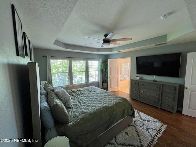 11110 Castlemain Cir S, Jacksonville, FL 32256 - bedroom featuring a raised ceiling, wood finished floors, ceiling fan, a textured ceiling, and ensuite bath