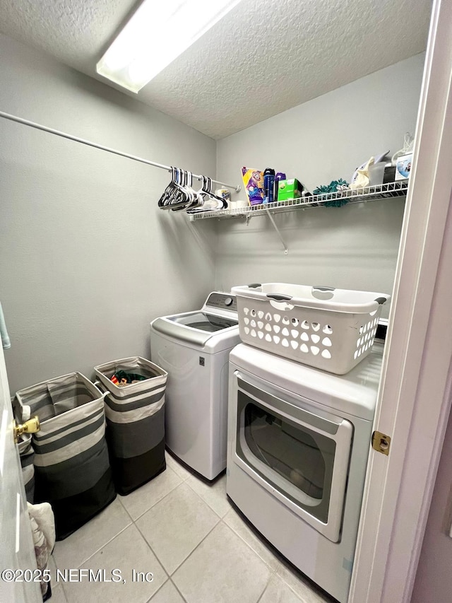 11110 Castlemain Cir S, Jacksonville, FL 32256 - laundry area featuring a textured ceiling, independent washer and dryer, and light tile patterned floors
