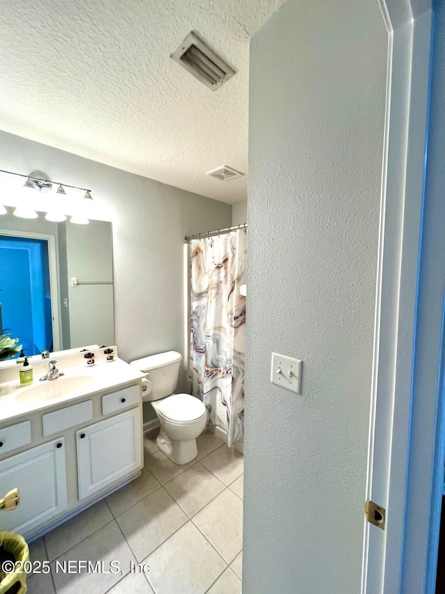 11110 Castlemain Cir S, Jacksonville, FL 32256 - bathroom featuring vanity, tile patterned flooring, a textured ceiling, a textured wall, and curtained shower